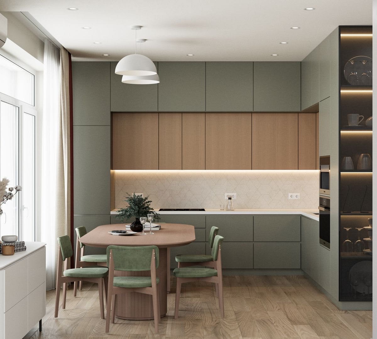 Open kitchen and dining space in sage green with oak shutters and velvet chairs