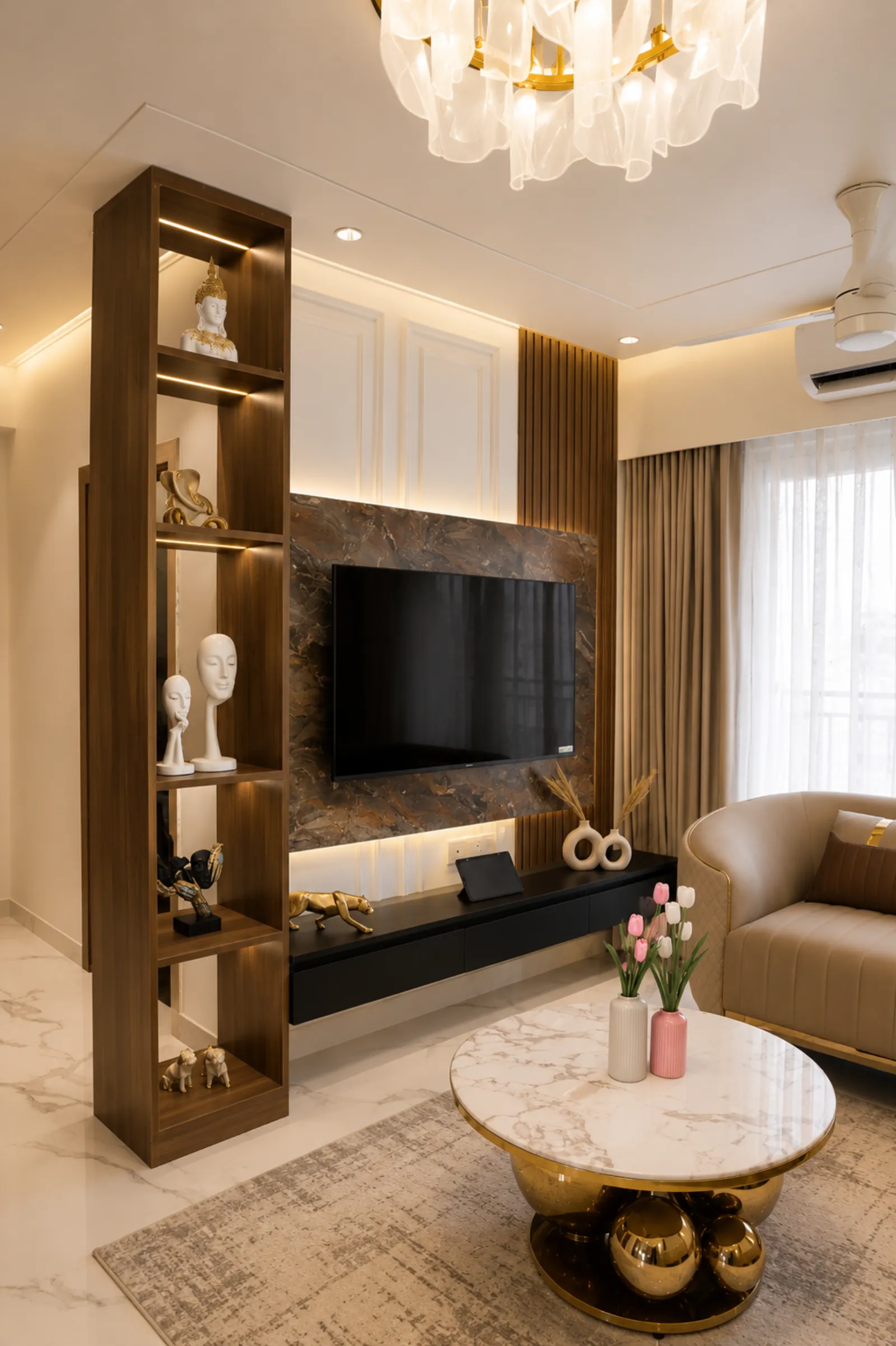 Living room with a sculptural dark-wood display column and a brass coffee table